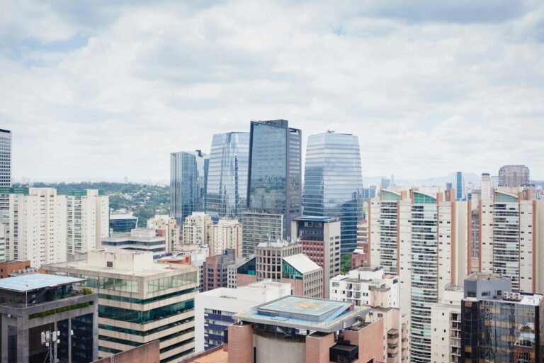 Aerial view of Sao Paulo showcasing modern architecture and skyline under a cloudy sky.